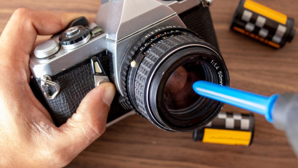 camera lens cleaning by air brush